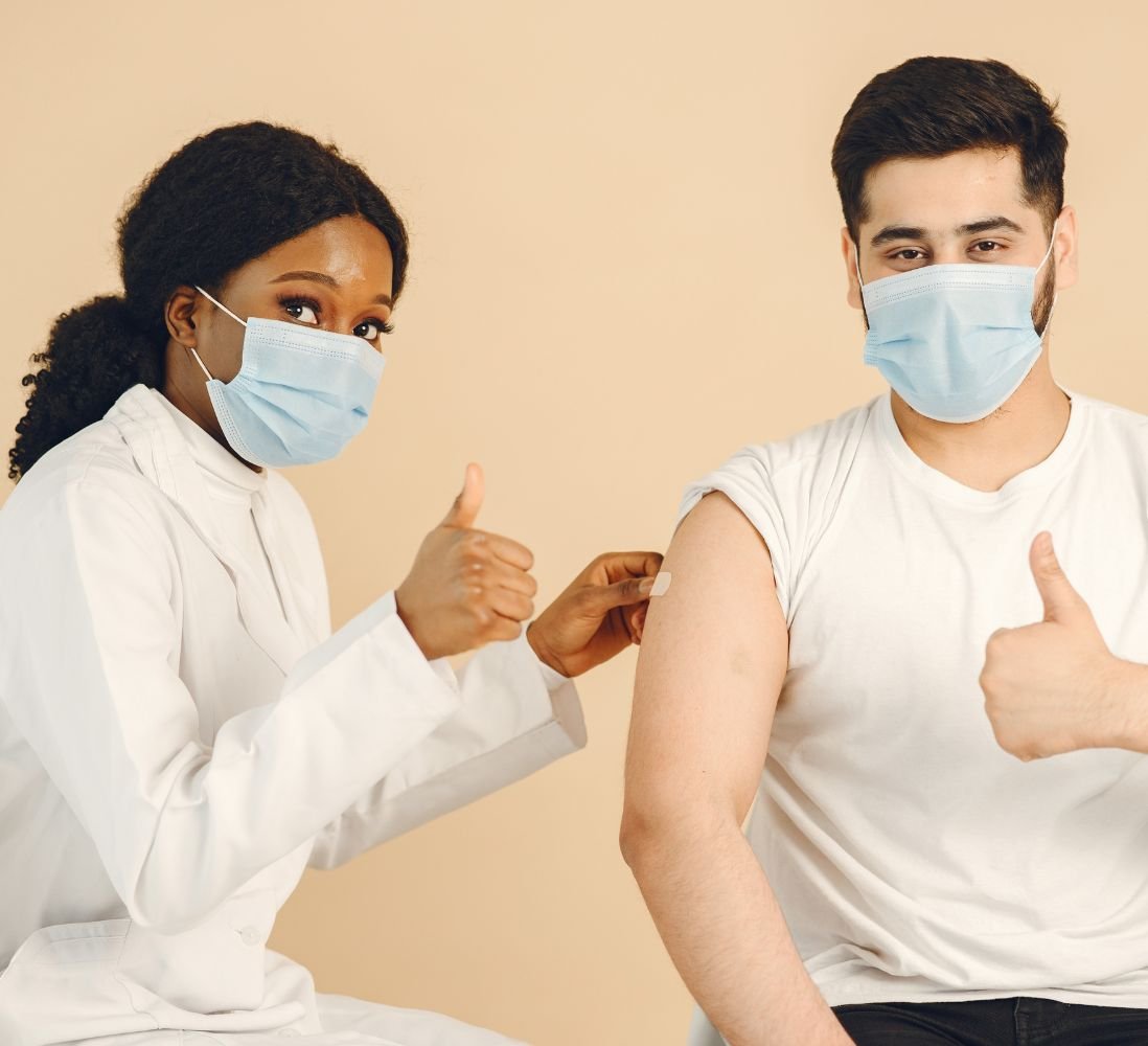 Employees giving a thumbs up after their workplace vaccinations