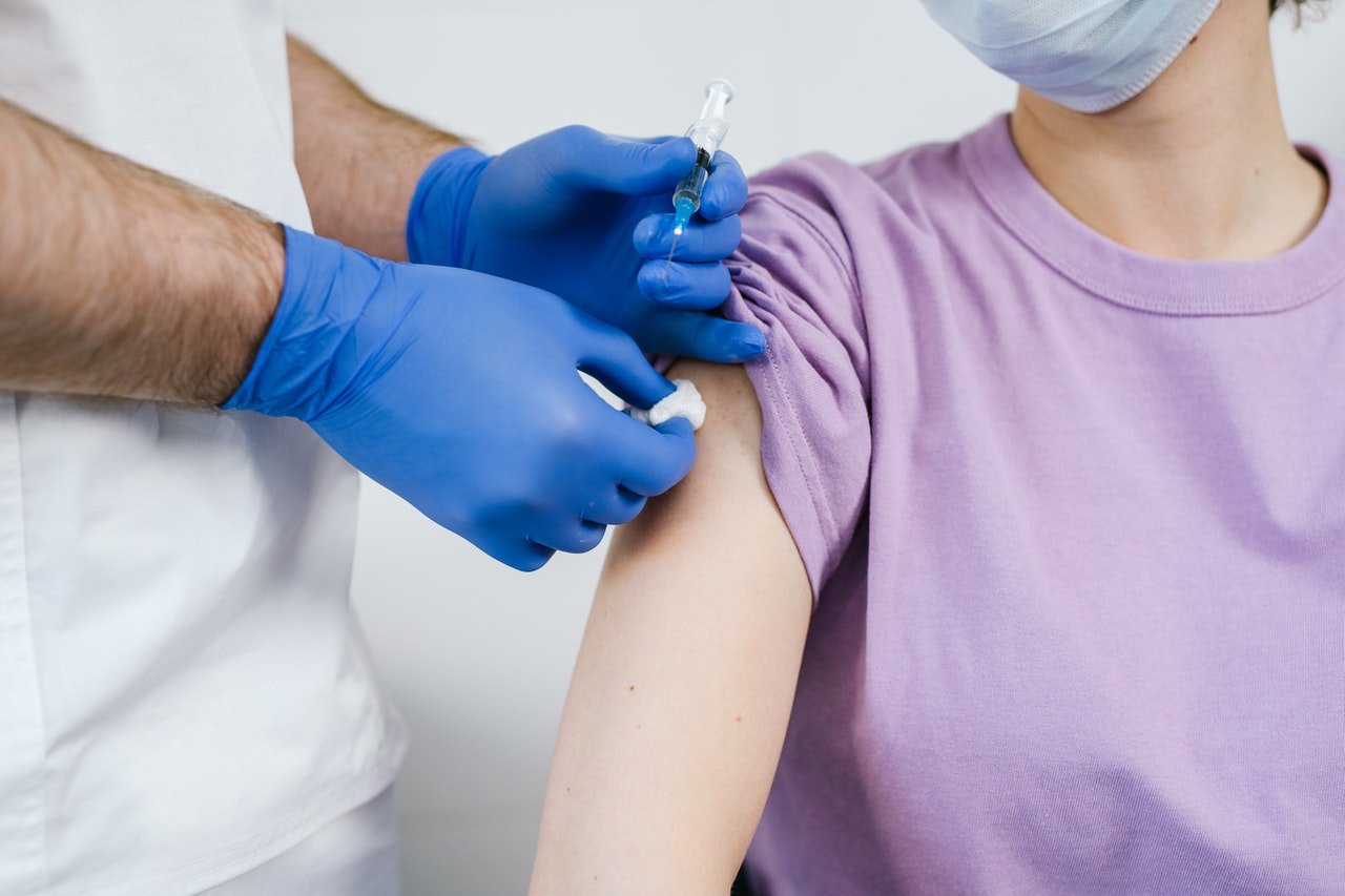 Nurse administering an on-site flu vaccination to an employee